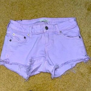 Lilac frayed stretchy mini jean shorts from Aritzia